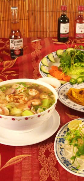 Noodle House favorites such as Yellow Noodle Soup, on the left, various beverages, herbs and vegetables to add to dishes, and a tiny view of the Vietnamese savory crepe in the center right.