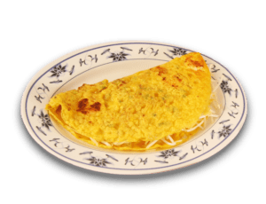 A plate of Banh Xeo, or Vietnamese Country Style Crepes showing the yellow crepe folded over with some bean sprouts sticking out of the open edges, the plate a bone colored ceramic with dark monochrome floral patterns around the edge, floral pattern consisting of lilies and lotuses